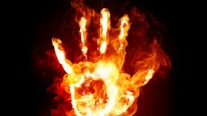 Fiery hand against black background