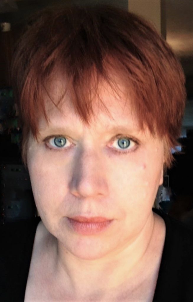 Middle aged white woman with red hair, headshot