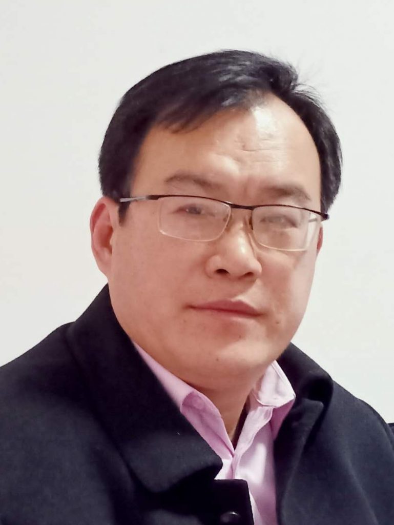 Headshot of a middle aged Asian man with glasses.