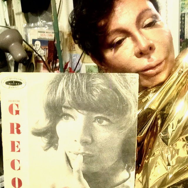 Italian man in the upper right corner with dark short hair and stage makeup and a gold shiny outfit, Juliette Greco album in the lower left corner.