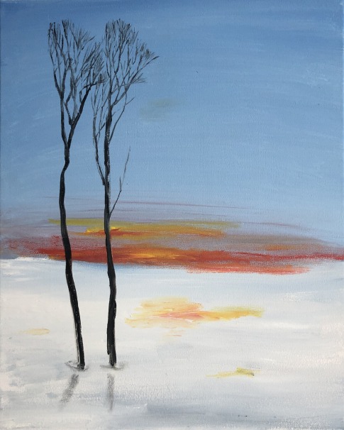 Tall leafless trees, two right next to each other, brown thin trunks in a blue pond with a red and orange sunset reflected in the water