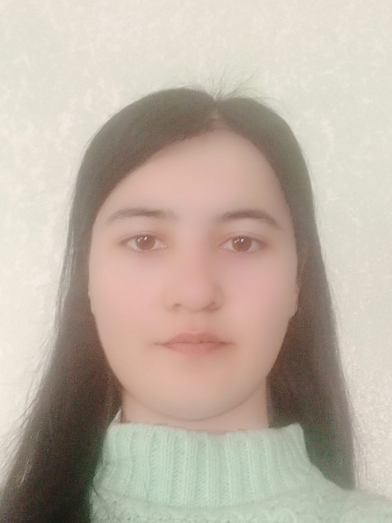 Headshot of a young Central Asian woman with brown eyes and straight brown hair and a turtleneck sweater. 