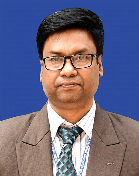 Middle aged South Asian man with short black hair, glasses, a colorful tie, a white shirt and light brown jacket.