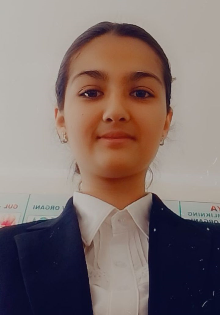 Young Central Asian girl with dark straight hair, brown eyes, earrings, and a white collared shirt and black or blue jacket. 