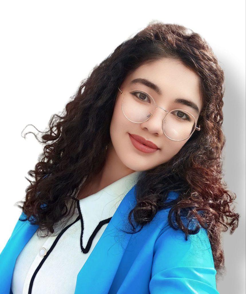 Central Asian teen girl with dark black curly hair, a white blouse and a light blue jacket. 