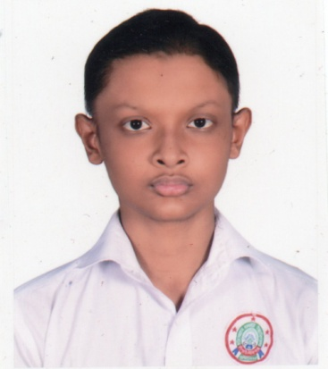 Young South Asian boy with short brown hair, brown eyes, and a white collared school uniform shirt with a decal on his chest. 