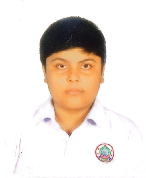 South Asian teen boy with short brown hair and a white collared school uniform shirt.