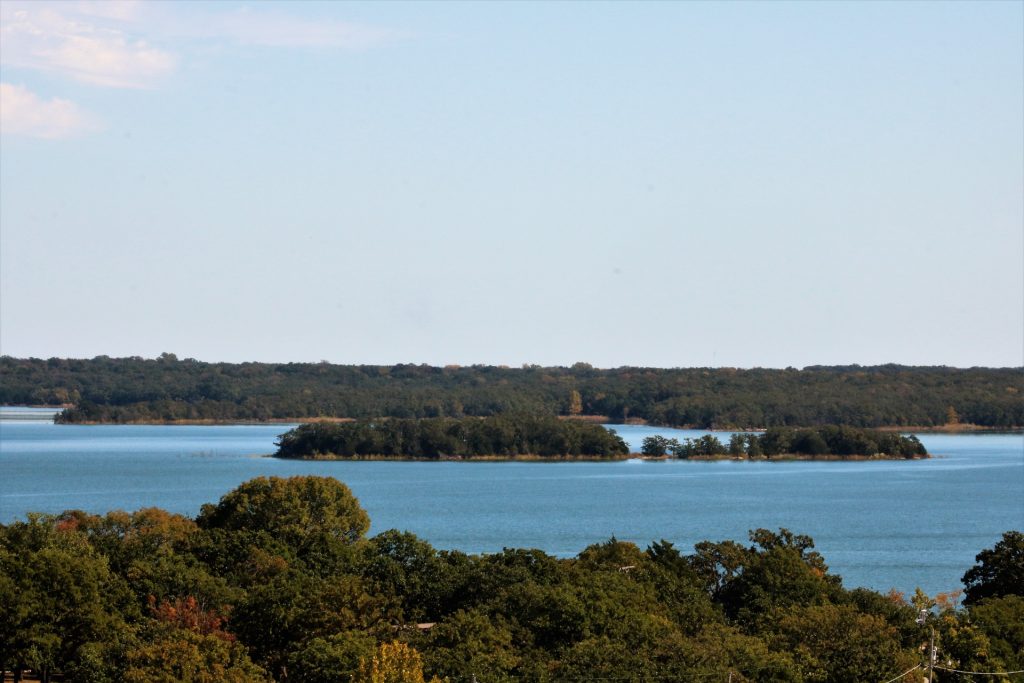 Aerial view of a lake with small islands full of trees. 