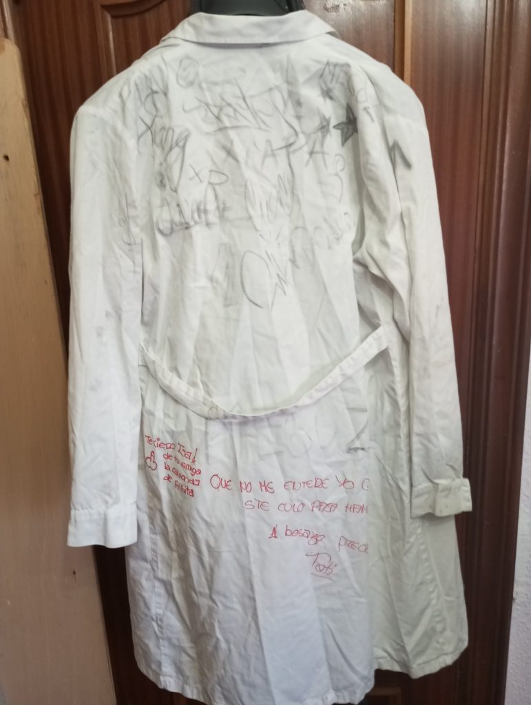 White smock with autographs written on it. 