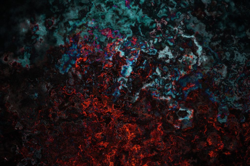 Abstract image of rock or paint in red and blue-silvery green colors melting into each other. 