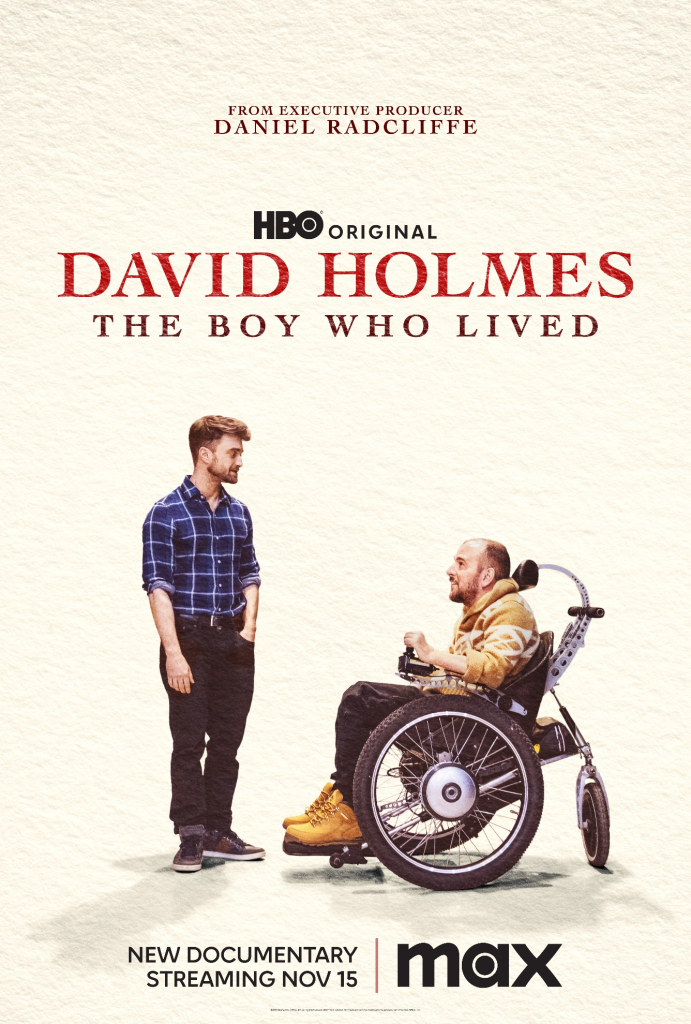 Movie poster for David Holmes' The Boy Who Lived. Young white man with a blue and white polo shirt and black jeans and black tennis shoes standing and looking at a older white man with a brown jacket, black jeans and brown shoes in a wheelchair who's also looking at him. 