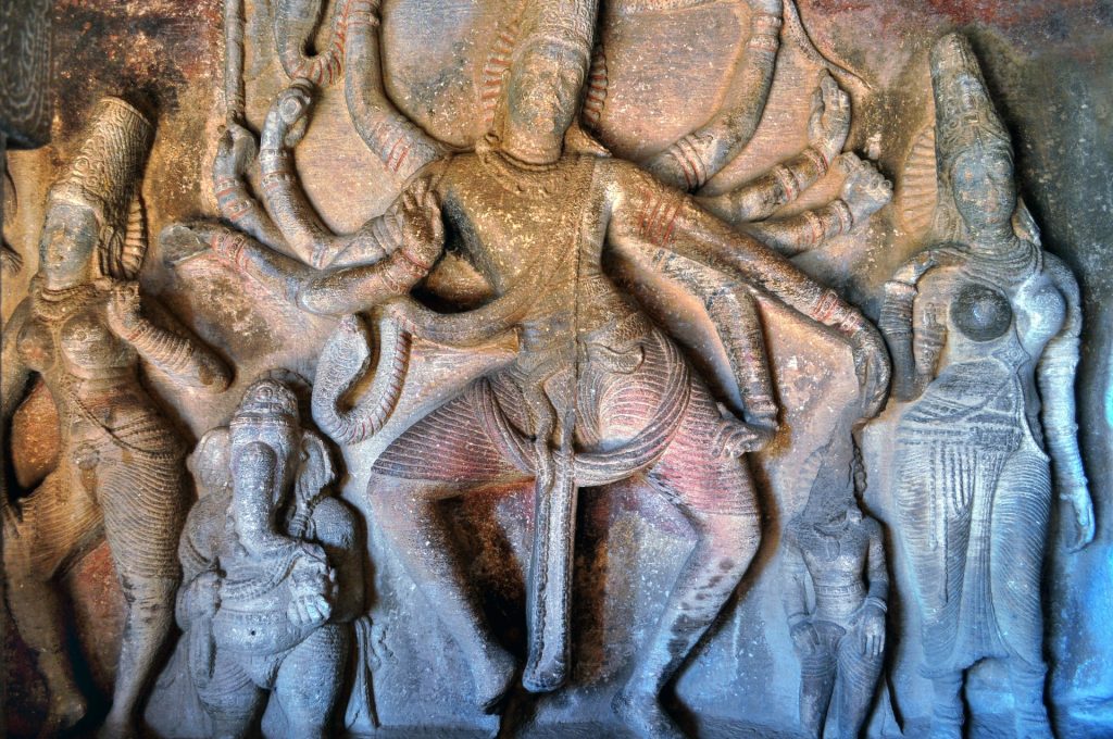 Stone carving of Lord Shiva dancing with his many arms and his family, including Lord Ganesha with the elephant head. 