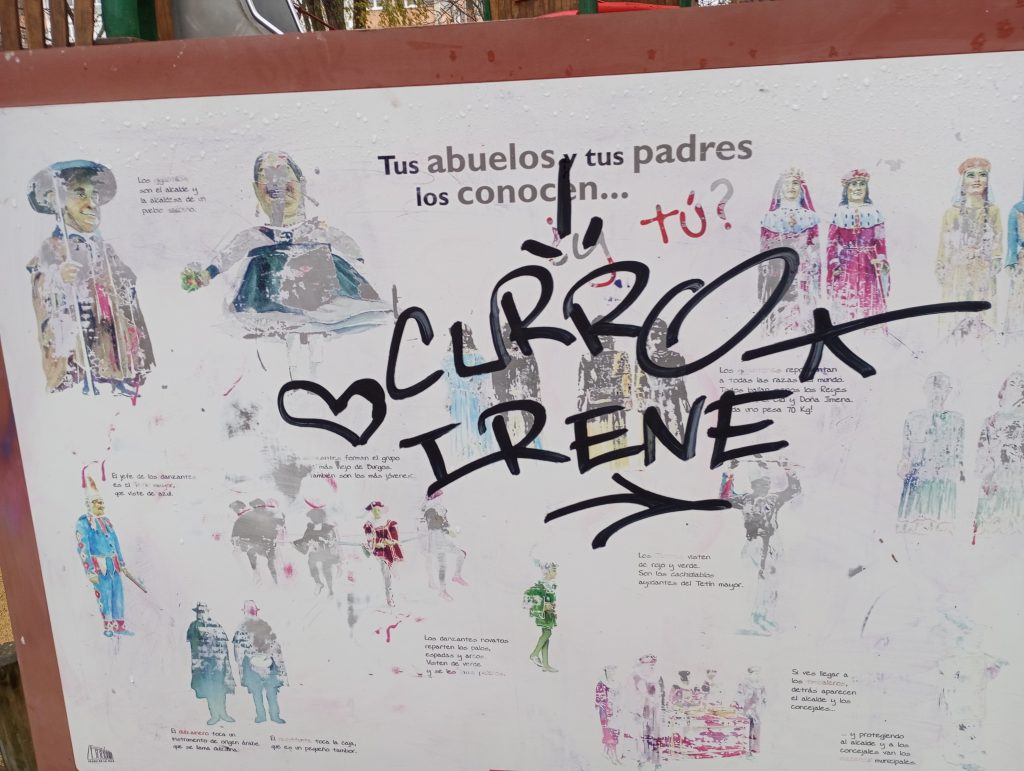 Poster in Spanish that asks if your parents and grandparents know certain people. It's faded and "Curro Loves Irene" is scrawled on it in black marker. 