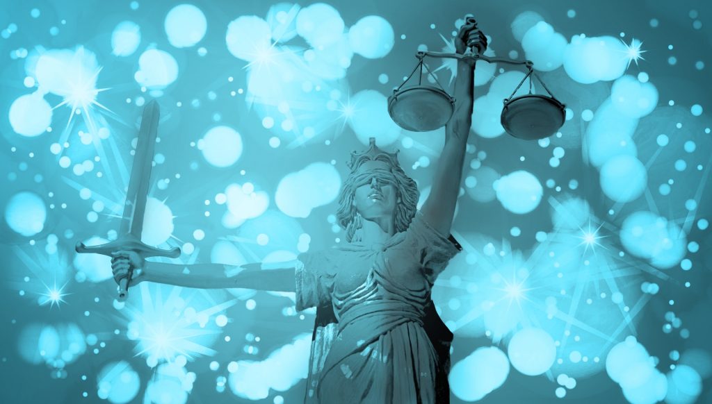 Triumphant blindfolded Lady Justice statue holding the empty scales and a sword in her outstretched arms. Green background with white stars and circles gives an ethereal feel. 