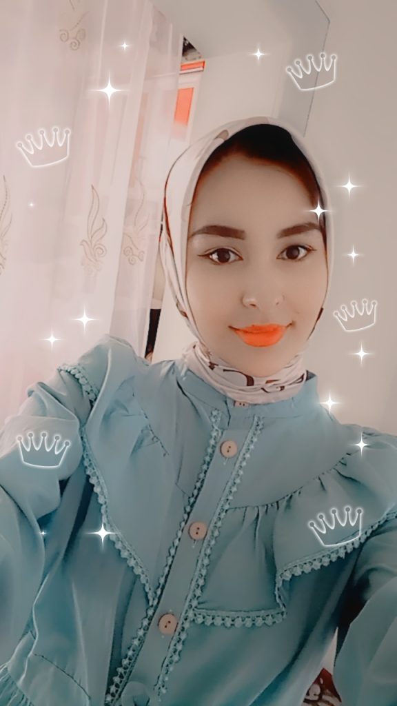 Teen Central Asian girl in a pink headscarf, bright orange-red lipstick, ruffly blue-green top, and Instagram filter crowns on the photo