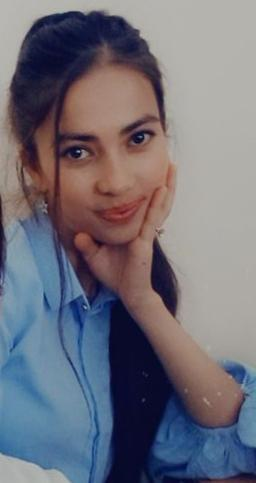 Central Asian teen girl with straight dark long hair, brown eyes, a blue collared shirt and her head in her hand. 