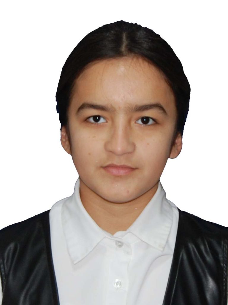 Central Asian teen girl with straight black hair behind her head. She's in a white collared shirt and a black vest.