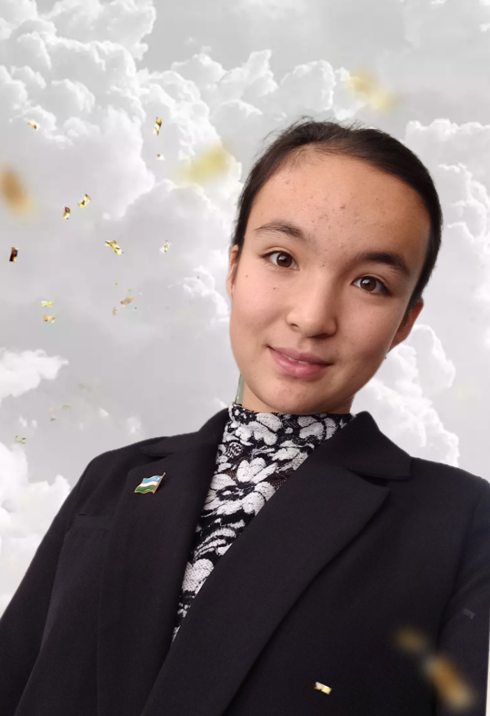 Central Asian teen girl with long dark hair behind her head, brown eyes, a black and white flowered blouse, and a black jacket with a pin of the Uzbek flag on her chest. A background with clouds is behind her. 