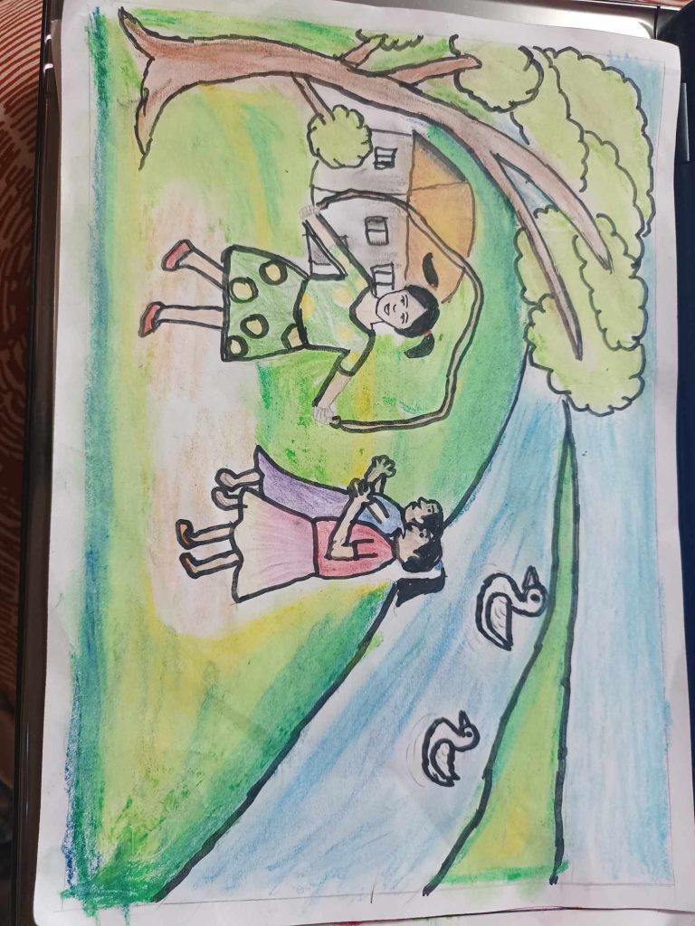 Girl in a yellow and green polkadot skirt and black pigtails jumps rope while two other girls in skirts applaud. She's under a tree and by a stream. Ducks swim on the water. 