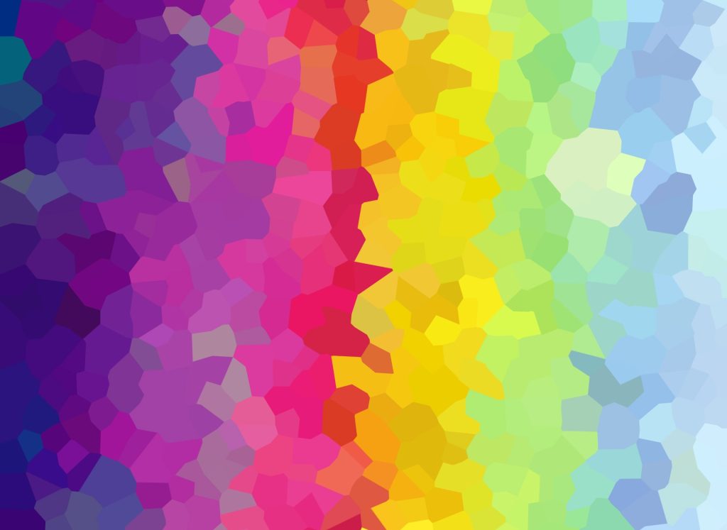 Mosaic of jagged images melding into each other in a rainbow with red in the middle and yellows, greens, and blues on the right and pinks, purples, and indigo on the left. 