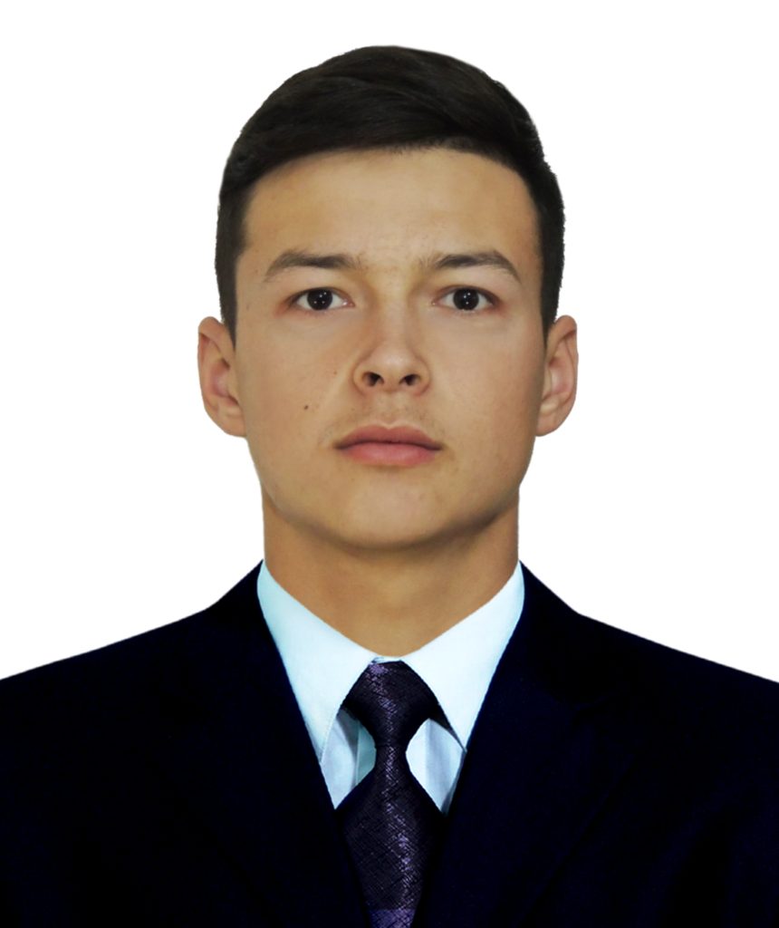 Central Asian young man with brown hair, brown eyes, and a white collared shirt under a black coat and a purple tie. 