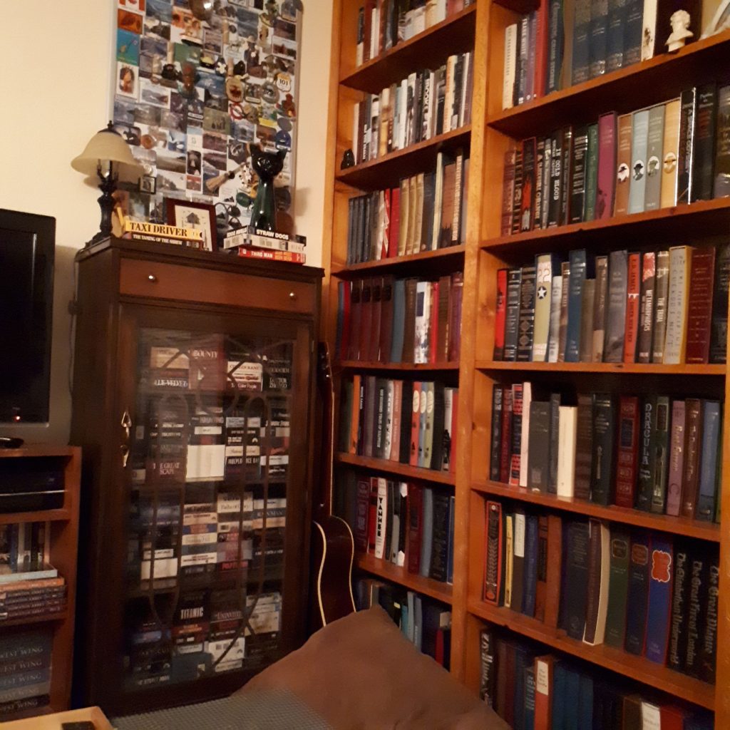 Large and full wooden cabinets and bookshelves full of books. 