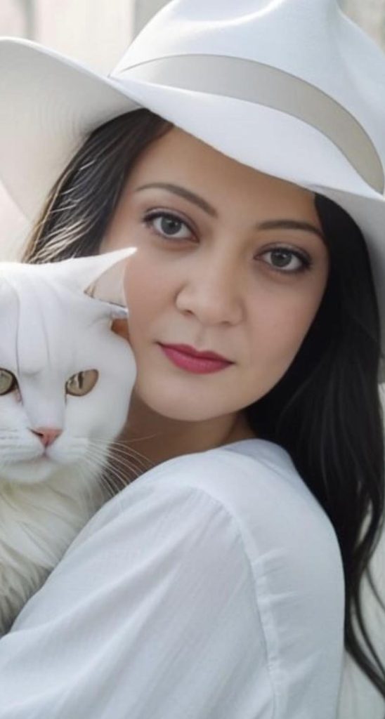 Woman with light skin, red lips, brown eyes and hair, a white large brimmed hat holding a white cat. 