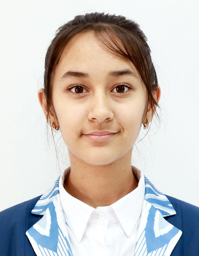 Central Asian teen girl with dark hair in a bun, brown eyes, earrings, and a blue jacket and white collared shirt. 