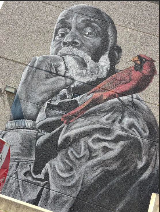 Painting of an older Black man with a beard resting his head on his fist. He's got on a jacket and a red cardinal is on his shoulder.