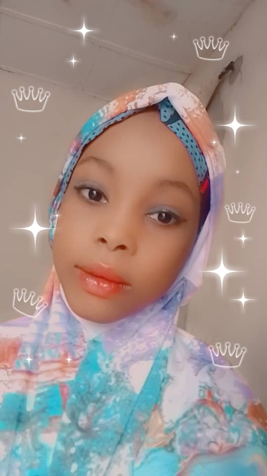 Light-skinned Black woman with red lipstick, eyeshadow, and a multicolored headscarf. Crowns and stars in the background.