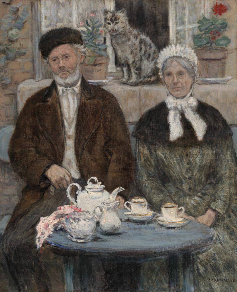 Elderly European couple in hats and coats and scarves seated with serious faces at teatime with a teapot and teacups on a table. Cat and houseplants and open window in the background.