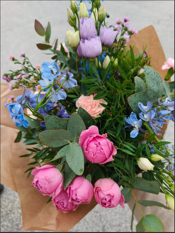 Bouquet of flowers with pink roses, blue and purple flowers