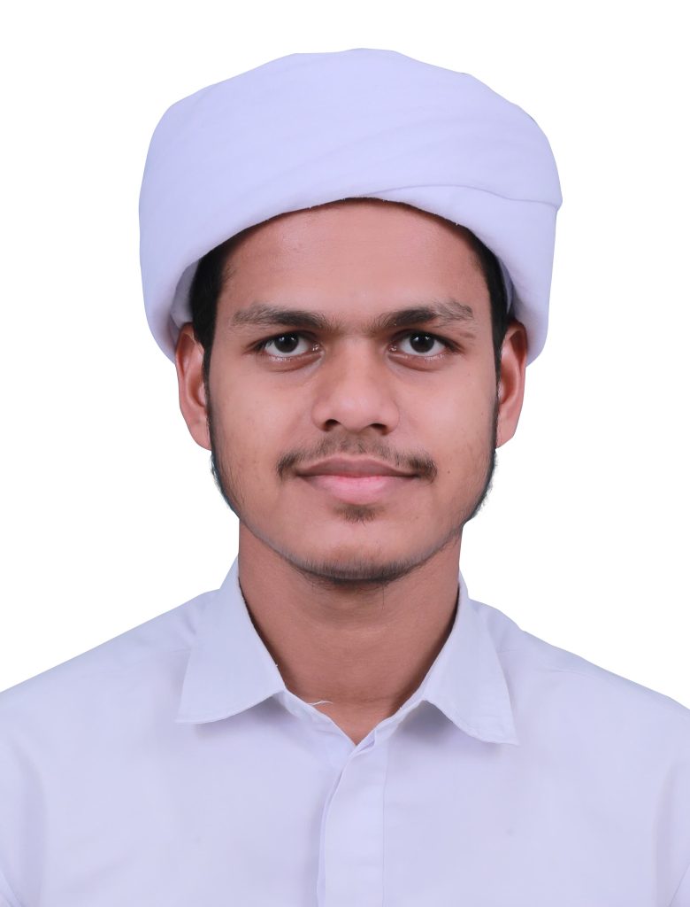 Young man of Arab heritage with a white collared shirt, clean shaven, and white headdress.