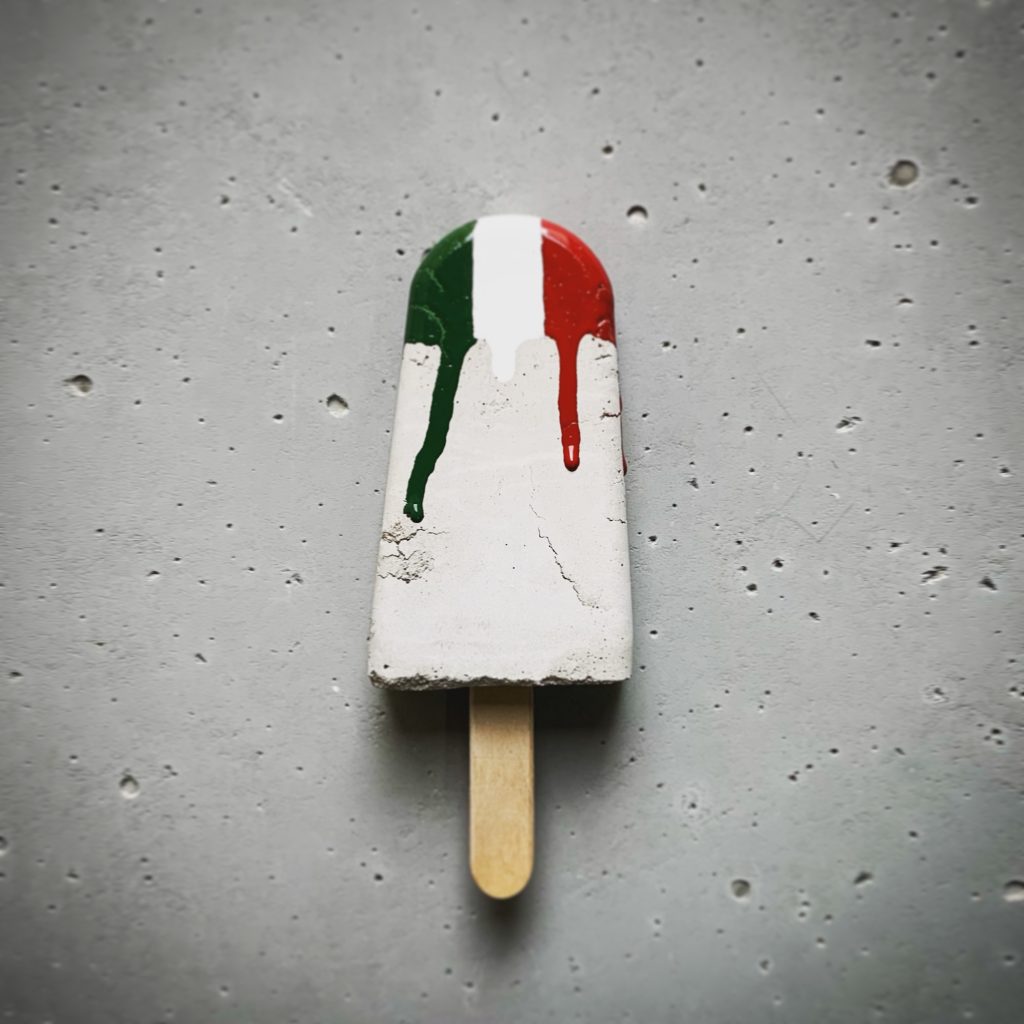 Concrete ice cream pop with dripping red, white, and green Italian flag colors. 