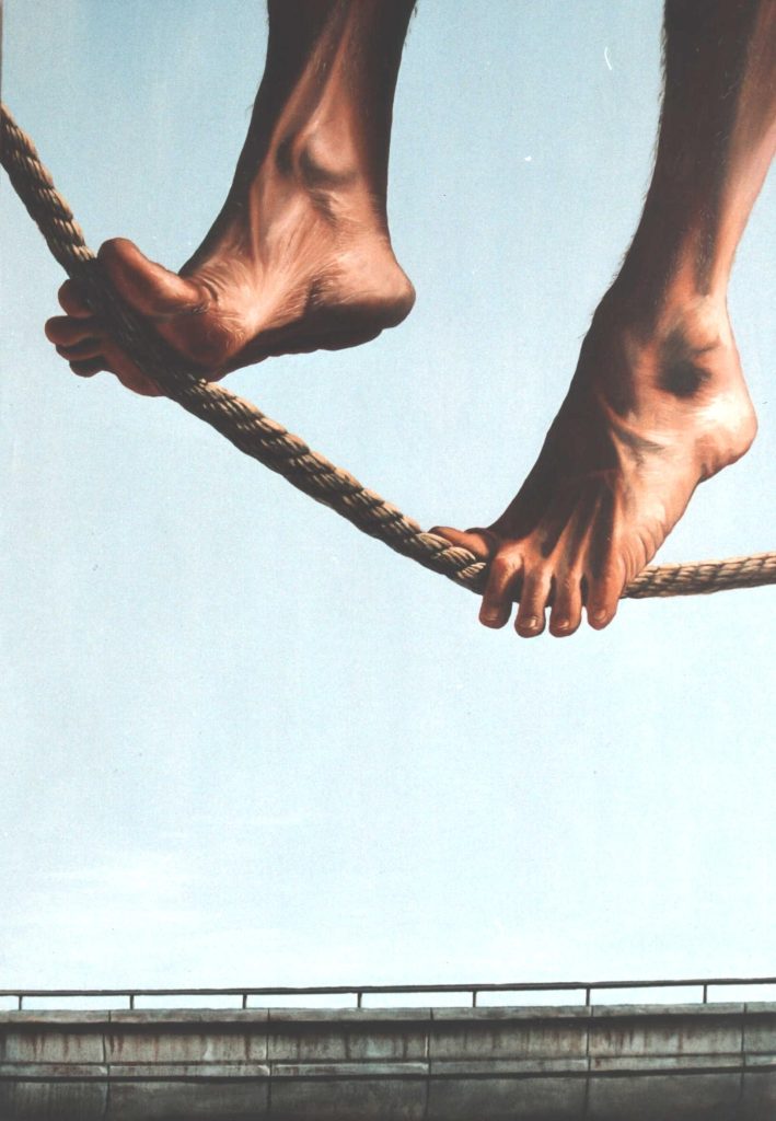 Closeup of bare feet on a tightrope