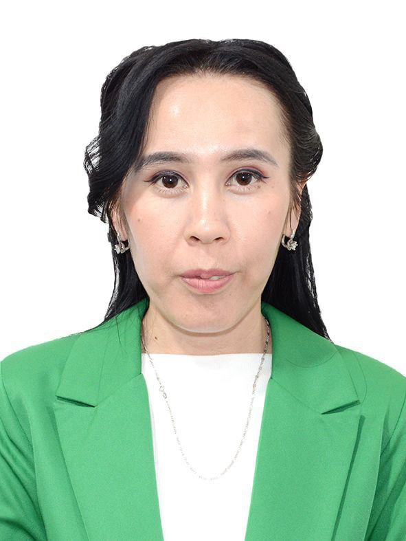Young Central Asian woman with long dark hair and brown eyes, shiny earrings and a necklace, green coat over a white top.