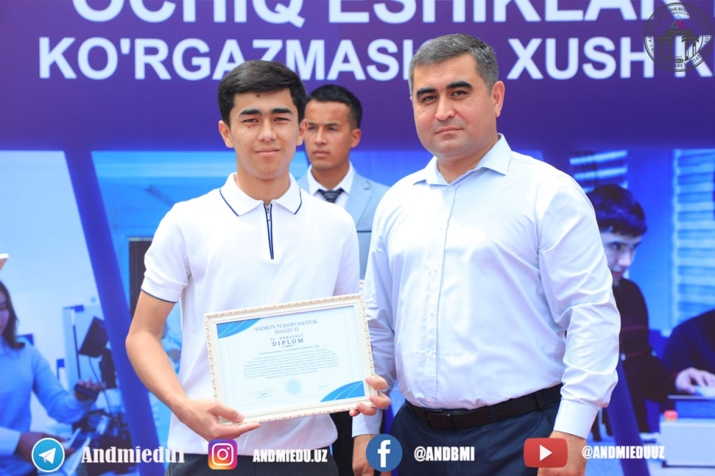 Young Central Asian man in a white collared shirt holding up a framed certificate standing next to two white-shirted older men.