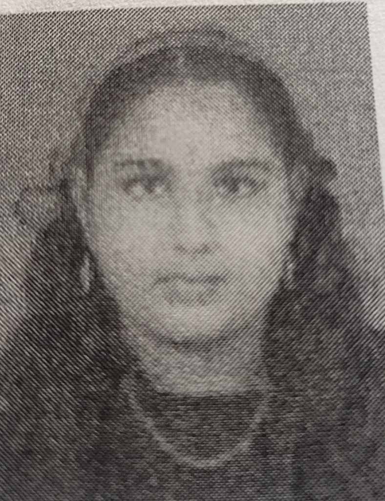 Pixelated gray image of a South Asian teen girl with earrings and dark curly hair.