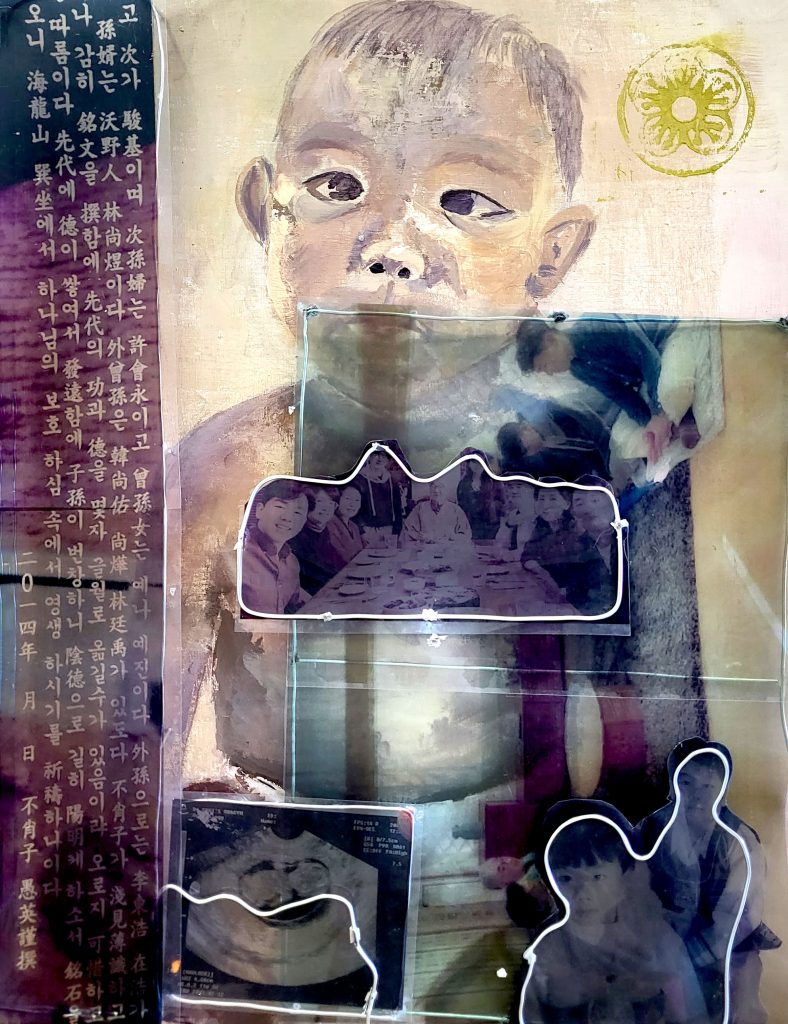 Small Asian baby with a photo of an Asian family eating a meal at a table together and a sonogram and some Asian writing superimposed. 
