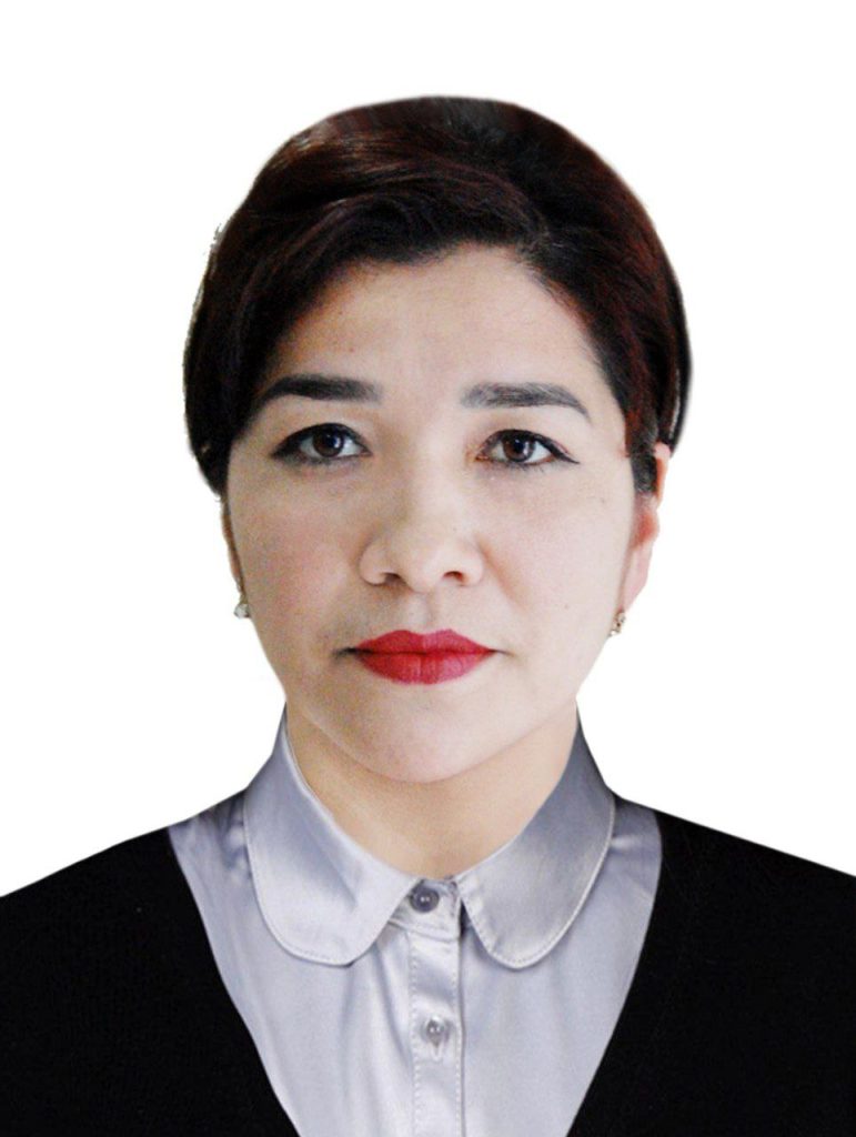 Young Central Asian woman with short dark hair, red lipstick, and a silver collared shirt and black coat. 