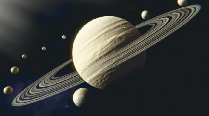 Closeup of Saturn with rings and several moons.