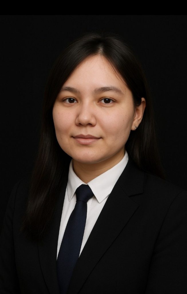 Young Central Asian woman with dark hair, a coat, suit, and black tie.