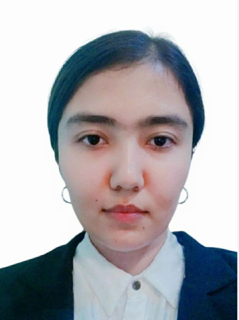 Young Central Asian woman with her long straight dark hair behind her head, brown eyes, small hoop earrings, and a black and white school uniform. 