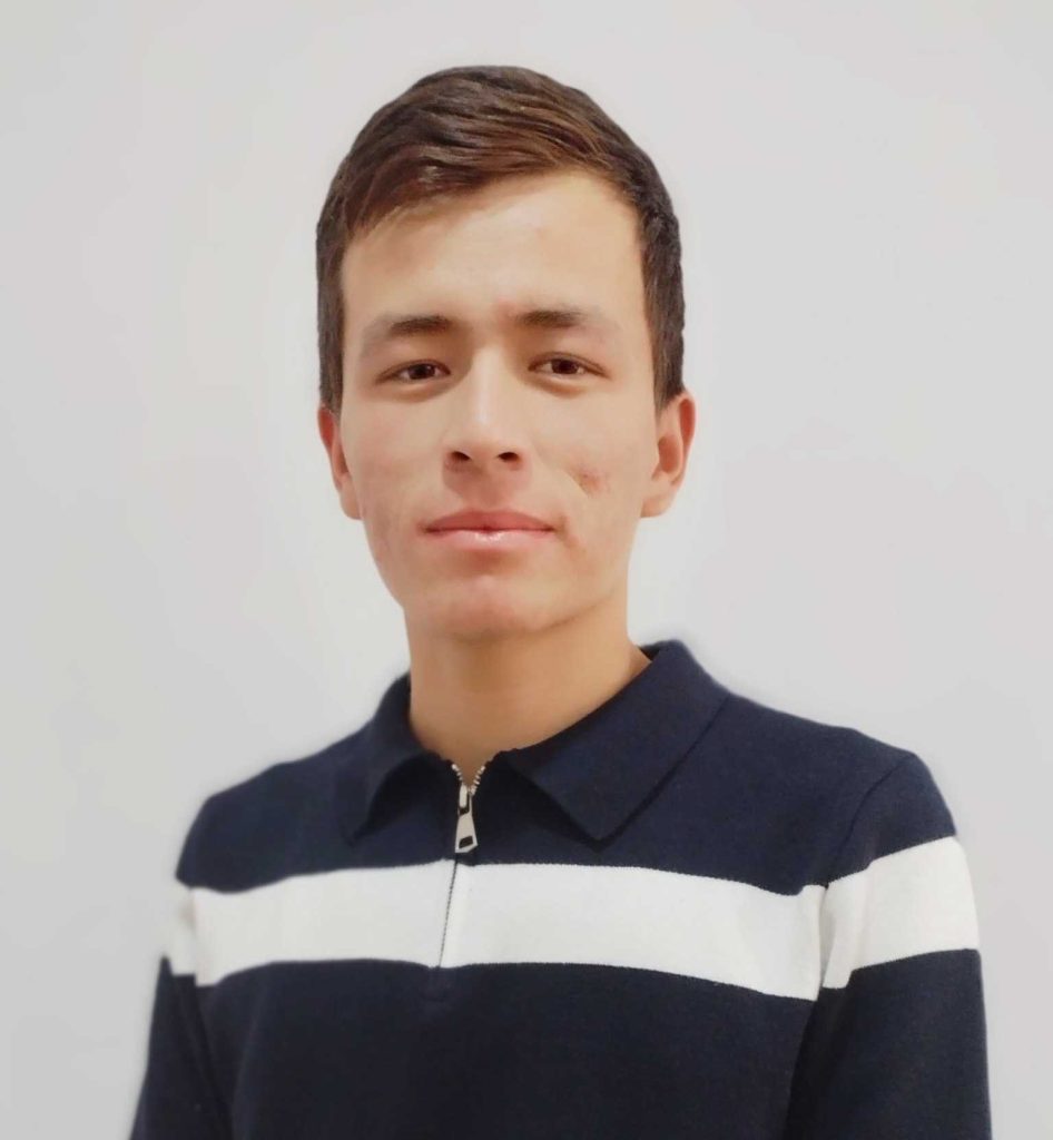 Young Central Asian guy in a striped tee shirt and short brown hair.