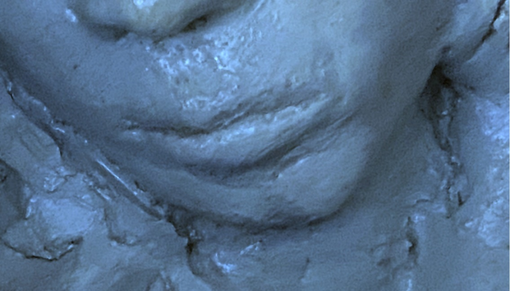 Close-up image of a clay sculpture of a human face. Each photo here is of a face from a slightly different angle, close up near the mouth.