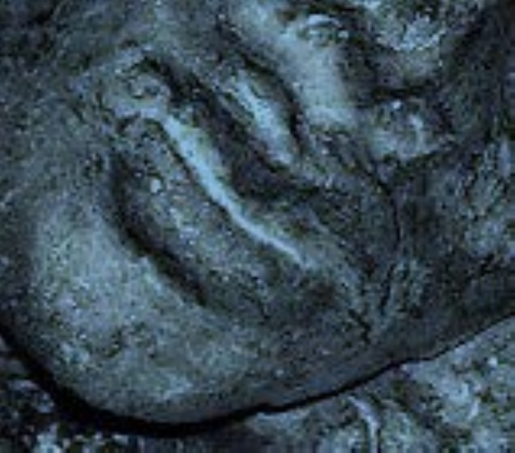 Close-up image of a clay sculpture of a human face. Each photo here is of a face from a slightly different angle, close up near the mouth.