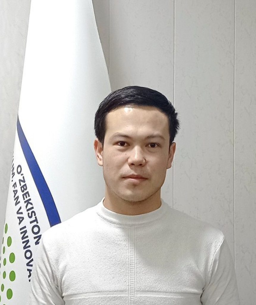 Young Central Asian man with dark short hair and a white long sleeved shirt. 