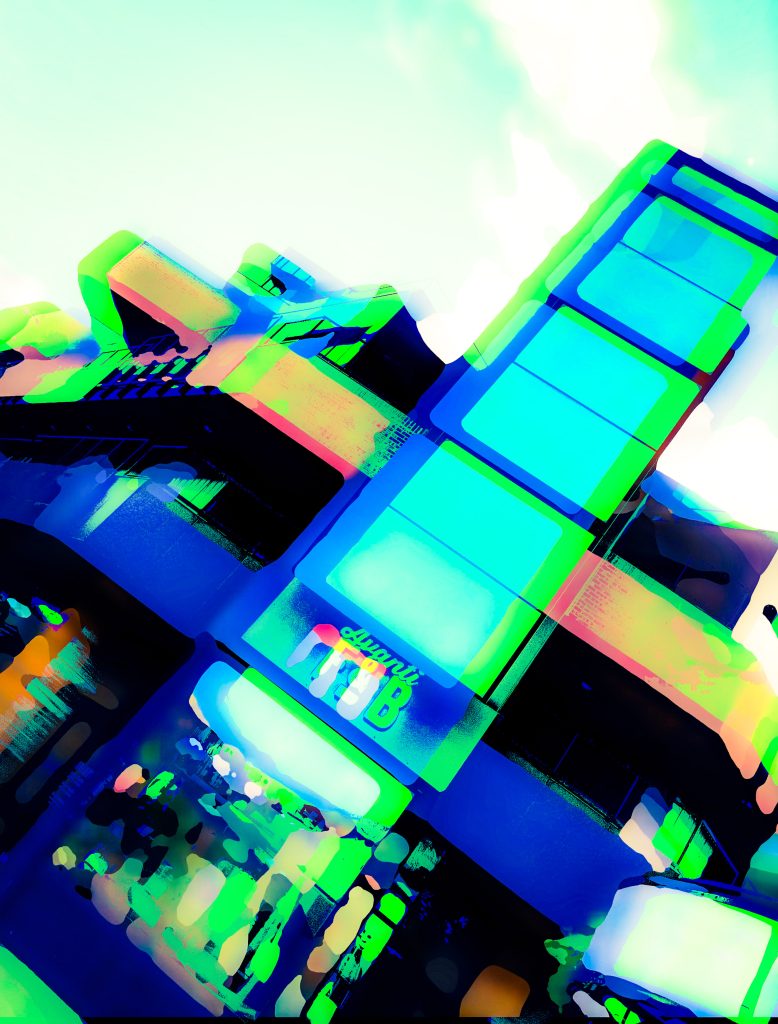 Blue and green haze on a commercial building with balconies. 