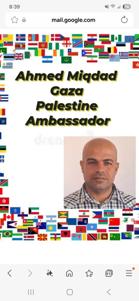 Image with a variety of national flags as a border. Black text on a white background reads "Ahmed Miqdad Gaza Palestine Ambassador" and then there's a photo of Ahmed, a middle aged bald man with brown eyes and a plaid tee shirt. 